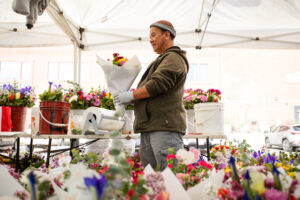Flower vendor surrounded by bouquets