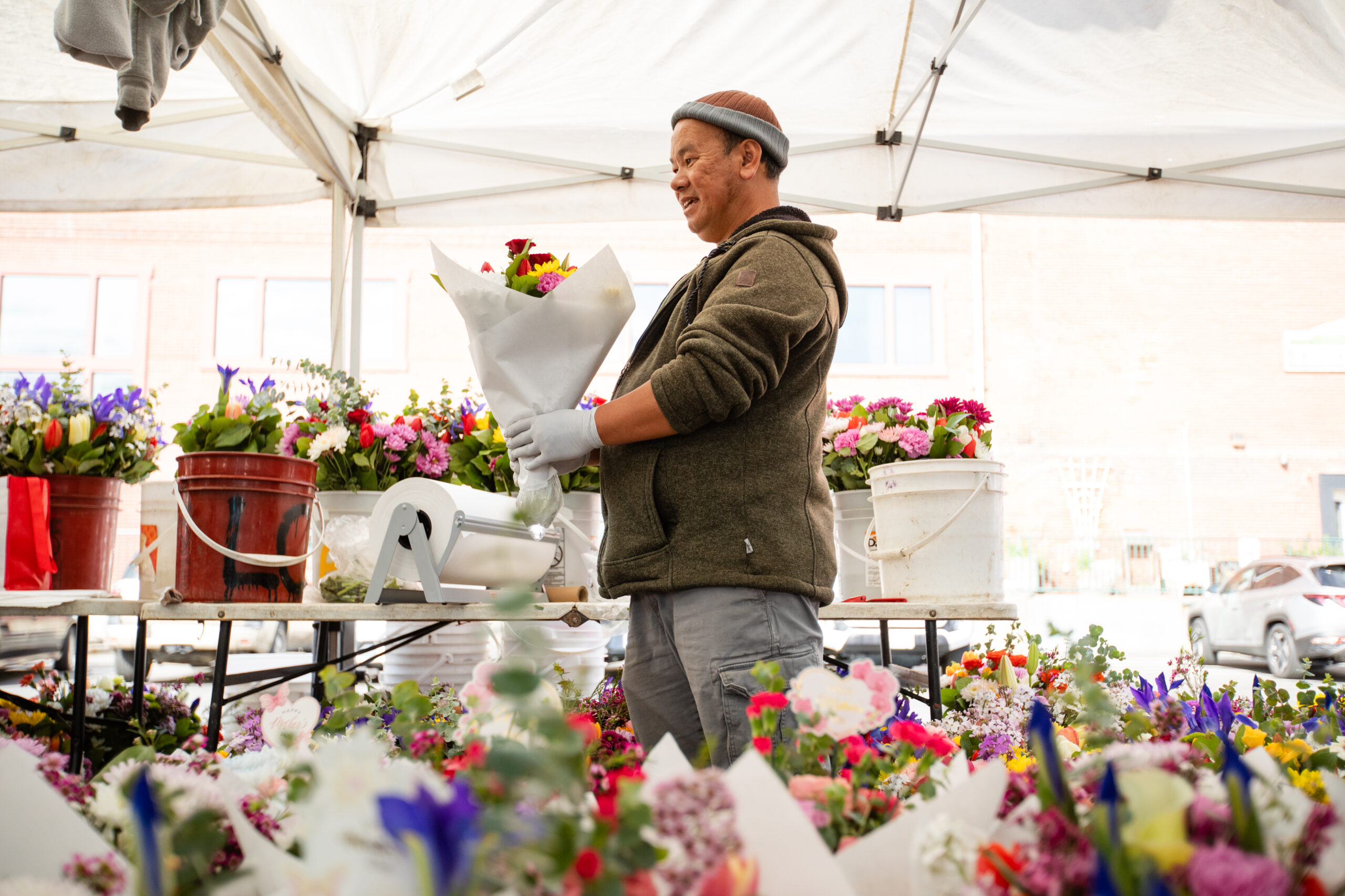Flower vendor surrounded by bouquets